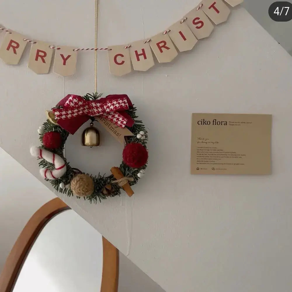 Christmas Gift Decorative Wreath for Home Decor hanging on wall with Merry Christmas banner.